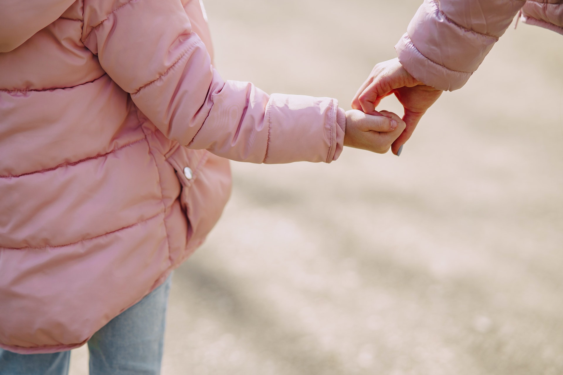crop-daughter-standing-hand-in-hand-with-mother-in-city-4127354